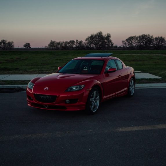 a red sports car parked in a parking lot